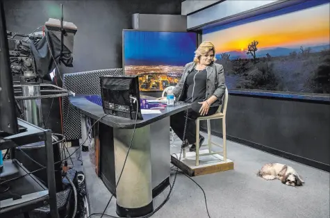  ?? L.E. Baskow Las Vegas Review-Journal @Left_Eye_Images ?? KPVM news director and anchor Deanna O’Donnell watches Tommy on set as she preps July 23 for her broadcast. The station is the subject of “Small Town News: KPVM Pahrump,” a six-episode HBO docuseries.