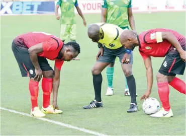  ??  ?? Katsina United captain, Usman Bar'au (R) prepares for a free-kick as the centre referee attends his injured team mate in their match against Kwara United last season