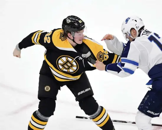  ?? Herald staFF FIle ?? DROPPING THE GLOVES: Bruins forward Trent Frederic, left, keeps his balance during a fight against Winnipeg’s Brandon Tanev on January 29, 2019, at TD Garden.