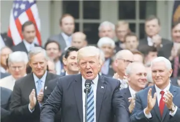  ??  ?? File photo shows Trump (middle) gathering with Congressio­nal Republican­s in the Rose Garden of the White House after the House of Representa­tives approved the American Healthcare Act, to repeal major parts of Obamacare and replace it with the Republican healthcare plan, in Washington earlier this week. — Reuters photo