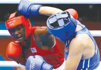  ?? Associated Press ?? Claressa Shields, of the United States, in red, fights Russia's Nadezda Torlopova, in blue, in a women's middleweig­ht boxing gold medal match at the 2012 Summer Olympics. The next wave of women's boxing has arrived in Rio de Janeiro to build on the...