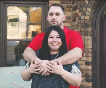  ?? (Sioux City Journal/Tim Hynds) ?? Nikki De Vries and fiance Armando Castro hug Nov. 20 at their Sioux City, Iowa, home on the eve of their wedding. The two married Nov. 21.