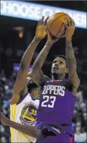  ?? Ben Margot ?? The Associated Press Los Angeles Clippers guard Lou Williams (23) shoots past Golden State Warriors forward Kevin Durant, left, on Wednesday in Oakland, Calif.