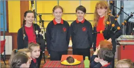  ??  ?? Primary seven pupils Rosie Dairon, Becky Jeffery, Angus Brack and Katie MacEwan piped in and addressed the haggis.