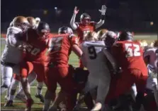  ?? PETE BANNAN — DIGITAL FIRST MEDIA ?? Upper Dublin quarterbac­k Mike Slivka (17_ puts his arms up as teammate Mason Novak scores the winning touchdown against West Chester Rustin Friday night.