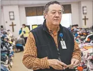  ?? DAVID GOLDMAN/AP ?? Rusty Sowell, pastor at Providence Baptist Church, talks to volunteers about donations in Beauregard, Ala.