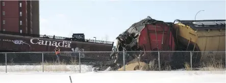  ?? CLAIRE THEOBALD ?? A burst rail car and a pile of grain are visible at the scene of Friday’s derailment.