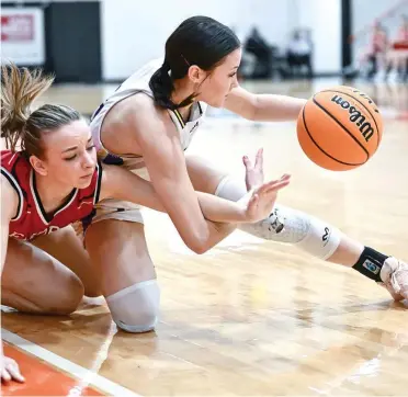  ?? ?? Fouke’s Connie Ross, right, battles a Flippin defender during first-round action in the Class 3A state basketball tournament in Lamar, Arkansas. The Lady Panthers defeated Flippin, 51-45, to advance to the Elite 8. (Photo by Ted McClenning)