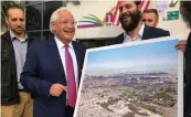  ??  ?? US ambassador to Israel David Friedman is pictured next to a man holding a poster of the Jewish Temple replacing the Muslim Dome on the Rock on Jerusalem’s Temple Mount, at an event in Bnei Brak on Tuesday.