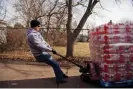  ?? ?? A delivery man hauls bottled water outside of the St Mark Baptist church in Flint, Michigan, on 23 February 2016. Photograph: Tom Williams/CQ-Roll Call, Inc/Getty Images