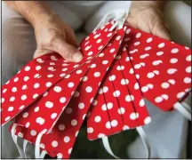  ??  ?? Krier shows a handful of her polka dotted masks she’s been making.