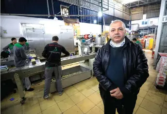  ??  ?? Wael Ai, head of al-Arees factory, poses for a photo inside his factory in Gaza City.