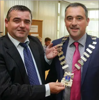  ??  ?? Cllr John Snell hands over the chain of office to Cllr Shay Cullen.