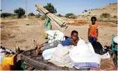  ?? Reuters ?? Ethiopian refugees sit on their belongings at the Um Rakuba refugee camp which houses Ethiopian refugees fleeing the fighting in the Tigray region.