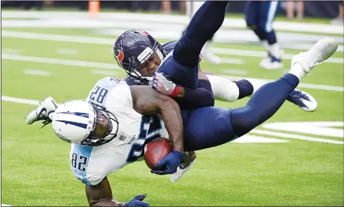  ?? (AP) ?? Tennessee Titans tight end Delanie Walker (82) is upended by Houston Texans defensive back Johnthan Banks (33) after making a catch during the second half of an NFL football game on Oct 1, in Houston.