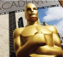  ?? (Photo by Matt Sayles/Invision/AP, File) ?? An Oscar statue stands outside the Dolby Theatre for the 87th Academy Awards in Los Angeles. This year's Oscars will be held Sunday, March 12. The ceremony is set to begin at 8 p.m. EST and be broadcast live on ABC. Jimmy Kimmel will host for the third time and his first time since 2018.