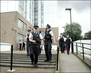  ?? AP/TIM IRELAND ?? Police officers patrol outside Dorney Tower, part of the Chalcots Estate in the borough of Camden, north London, on Sunday.