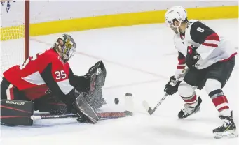  ??  ?? Ottawa goaltender Marcus Hogberg made 32 stops, including this one on Arizona’s Nick Schmaltz.