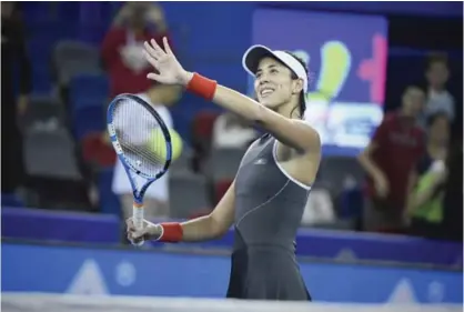  ??  ?? WUHAN: Garbine Muguruza of Spain celebrates after winning against Magda Linette of Poland during their third round women’s singles match at the WTA Wuhan Open tennis tournament in Wuhan, in China’s central Hubei province yesterday. — AFP