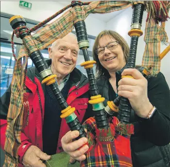  ?? Photograph: Iain Ferguson, alba.photos ?? John MacDonald presents the historical bagpipes to Margaret MacMaster of Lochaber Schools Pipe Band.