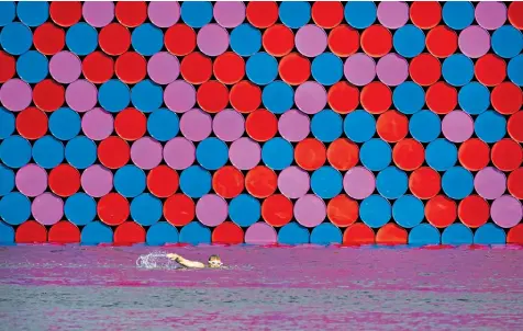  ??  ?? Christo’s 20m-high The London Mastaba consists of 7,506 barrels, floating in The Serpentine in Hyde Park, London. The geometric installati­on has attracted mixed reviews