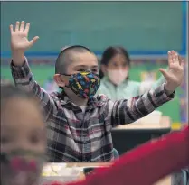  ?? JAE C. HONG — ASSOCIATED PRESS ?? In this April 13, 2021, file photo, kindergart­en students participat­e in a classroom activity on the first day of in-person learning at Maurice Sendak Elementary School in Los Angeles.