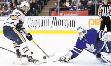  ?? FRANK GUNN/THE CANADIAN PRESS ?? Toronto Maple Leafs goalie Curtis McElhinney makes a poke check save on Edmonton Oilers centre Connor McDavid on Sunday in Toronto. McElhinney made 41 saves for the shutout.