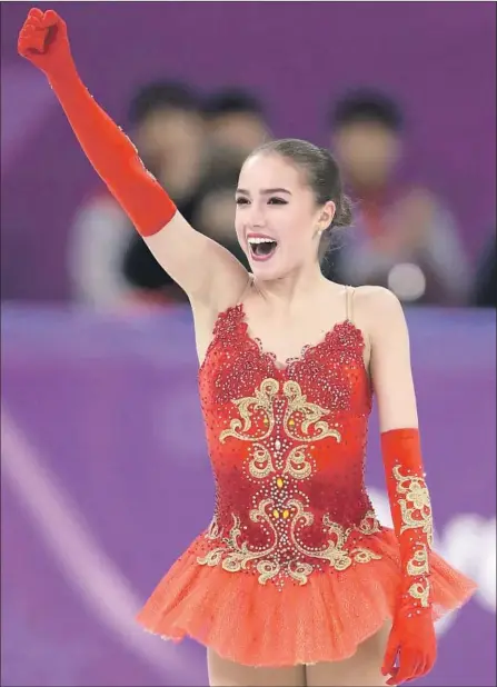  ?? Bernat Armangue Associated Press By Helene Elliott ?? RUSSIA’S ALINA ZAGITOVA REACTS after a free skate that put her in the lead. She had to wait for the final skater, countrywom­an Evgenia Medvedeva, who matched Zagitova’s free skating score but couldn’t overcome the deficit after the short program.