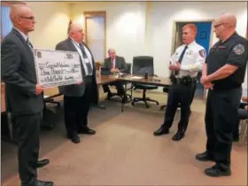  ?? EVAN BRANDT — DIGITAL FIRST MEDIA ?? Lower Pottsgrove Police Chief Mike Foltz, second from right, explains why bullet proof vests are not being issued to emergency medical technician­s like Erik Loshnowsky, right, from Goodwill Ambulance. Township Manager Ed Wagner, left, and Township...