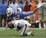  ?? JOHN RAOUX — THE ASSOCIATED PRESS FILE ?? In this file photo, Florida’s Chris Thompson, top, hits South Carolina’s Chris Lammons after he caught a punt during the first half of an NCAA college football game in Gainesvill­e, Fla. Thompson was penalized for targeting and was ejected from the game. College football’s most hated rule turns five years old in 2017. Targeting, which penalizes players for hits to the head with ejections, drives coaches, players and especially fans crazy, is here to stay and its supporters are adamant that it is a necessary part of the evolution of college football.