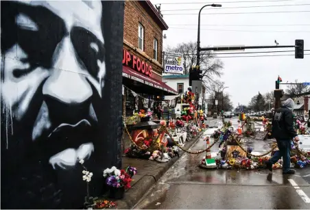  ??  ?? Recueillem­ent.
Le 10 mars, devant le mémorial dédié à George Floyd. Le procès de son meurtre par asphyxie par le policier Derek Chauvin a débuté la veille dans une atmosphère pesante.