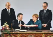  ?? AP ?? Angela Merkel and Emmanuel Macron, alongside the pair’s respective foreign minsters, Heiko Maas, right, and Jean-Yves Le Drian, in Aachen