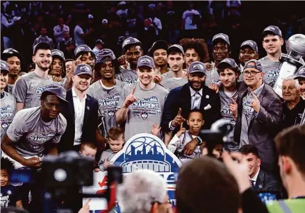  ?? Sarah Stier/Getty Images ?? The UConn men’s basketball team celebrates its Big East tournament championsh­ip on Saturday night at Madison Square Garden.