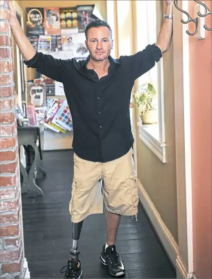  ?? Nate Guidry/Post-Gazette ?? John Siciliano, a Pittsburgh actor who is beginning a recurring role on CBS' "Bull." stands in a hallway at Big Dog Coffee on the South Side. Mr. Siciliano has an artificial leg and his story line is part of CBS' initiative towards diversity.