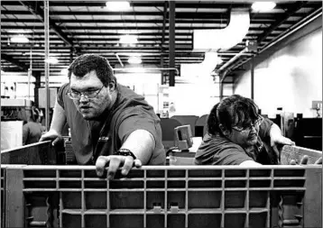  ?? CALLA KESSLER/FOR THE WASHINGTON POST ?? Colton Channon, left, was hired by Dee Zee Manufactur­ing, an Iowa firm that makes truck and SUV accessorie­s.