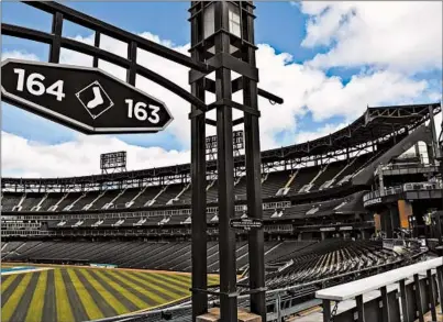  ?? ZBIGNIEW BZDAK (WRIGLEY FIELD) JOSE M. OSORIO (GUARANTEED RATE FIELD)/CHICAGO TRIBUNE ?? An empty Wrigley Field, top, on March 23 and an empty Guaranteed Rate Field, above, on May 8.