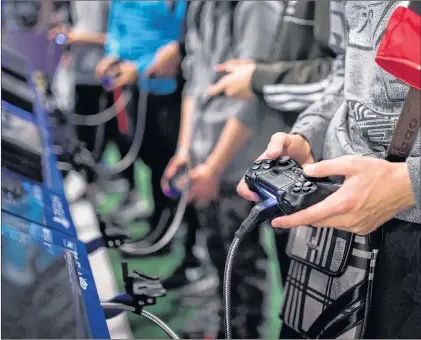  ?? AP PHOTO ?? The World Health Organizati­on says that compulsive­ly playing video games now qualifies as a new mental health condition, in a move that some critics warn may risk stigmatizi­ng its young players.
