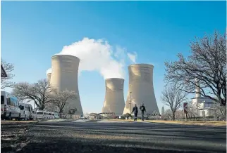  ?? /Reuters ?? Excluded from asset base: Workers near the cooling towers of the Hendrina power station, south of Middelburg, Mpumalanga, in 2018.