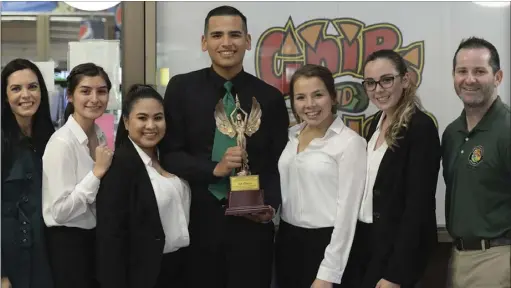  ??  ?? Holtville High School debate team showcases their first place trophy during the 2018 ICOE-Migrant Education Region Speech and Debate tournament on Saturday at Imperial Valley College. EDWIN DELGADO PHOTO