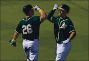  ?? MATT YORK — THE ASSOCIATED PRESS ?? The A’s Matt Olson greets Matt Chapman (26) after hitting a solo home run against the Los Angeles Angels on Friday.