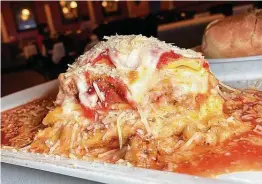  ??  ?? Lasagna incorporat­es beef, tomato sauce, ricotta and mozzarella cheeses at Scuzzi's Italian Restaurant on Loop 1604.