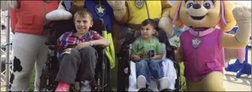  ?? NICOLE MILLER VIA AP ?? In this Sept. 10 photo, Jacob Green, 7, (center left) and his brother Alexander, 4, are surrounded by costumed actors as they are discharged from a hospital in Orchard Park, N.Y.