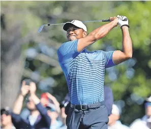  ?? BRAD PENNER/USA TODAY SPORTS ?? Tiger Woods follows through after hitting from the seventh tee during Tuesday’s practice round at Shinnecock Hills.