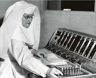  ?? Chronicle file ?? Sister Anthony Marie, in 1954, studies a graphic record of electrical impulses within a human brain, recorded in the newly-opened department
