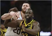  ?? JED JACOBSOHN — THE ASSOCIATED PRESS ?? Warriors forward Draymond Green (23) fights for a rebound with Phoenix Suns center Jusuf Nurkic (20) during the second half in San Francisco on Feb. 10.