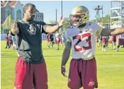  ?? JOE REEDY/AP ?? FSU running backs coach Donté Pimpleton gives Cam Akers instructio­n during the first day of spring practice. Akers broke FSU’s freshman rushing record last season.