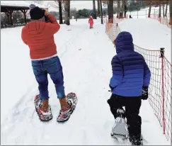  ?? Tina Weiner / Contribute­d photo / ?? A father and his children snowshoe recently at Winding Trails in Farmington.