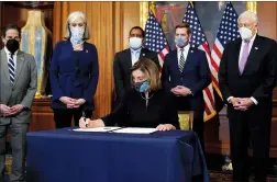  ?? AP PHOTO ALEX BRANDON ?? House Speaker Nancy Pelosi signs the articles of impeachmen­t against President Donald Trump in an engrossmen­t ceremony before transmissi­on to the Senate for trial on Capitol Hill, in Washington on Wednesday.