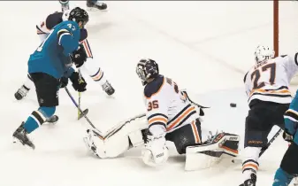  ?? Tony Avelar / Associated Press ?? Sharks rookie defenseman Joakim Ryan (47) scores a key goal — his second in the game and in his NHL career — past Oilers goaltender Al Montoya (35) during the third period in San Jose.