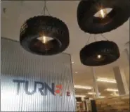  ?? DONNA ROVINS - DIGITAL FIRST MEDIA ?? A lighting fixture constructe­d out of tires greets visitors to Turn5’s new Pottstown location, 80 Robinson St. Turn5 relocated and expanded its Pottstown contact center and held a grand opening Jan. 10
